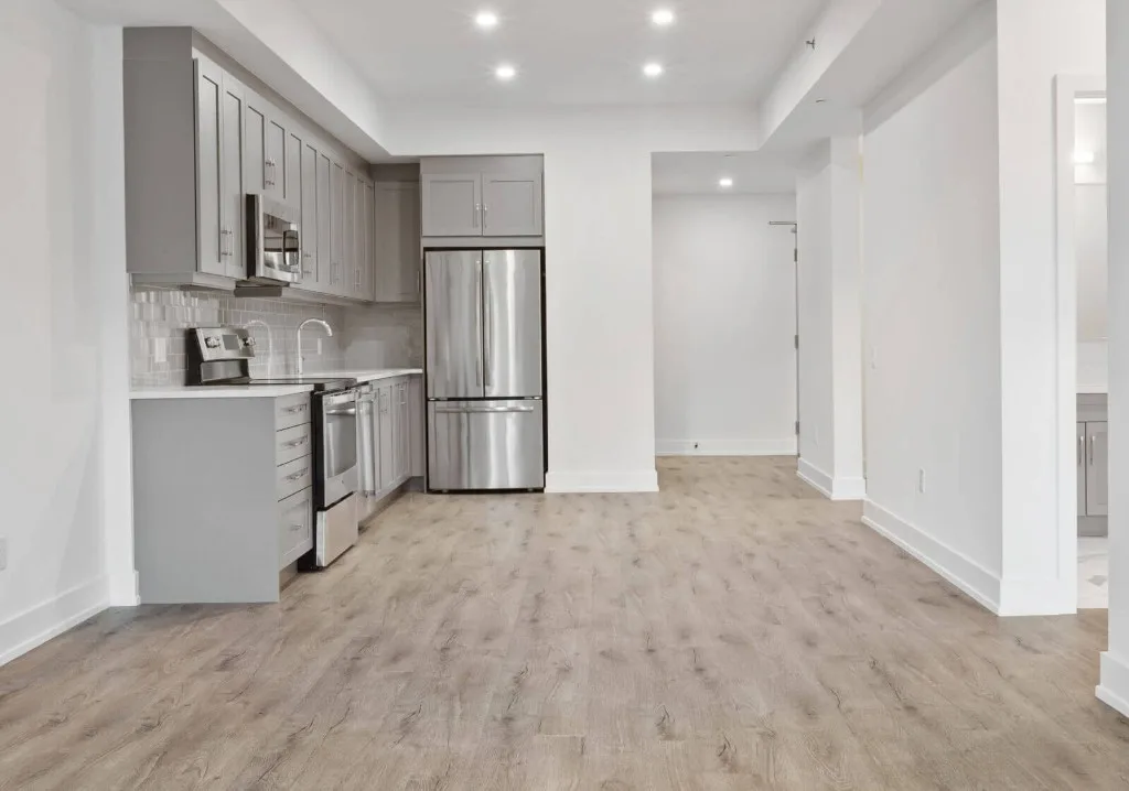 Apartment kitchen with light wood-look vinyl plank flooring