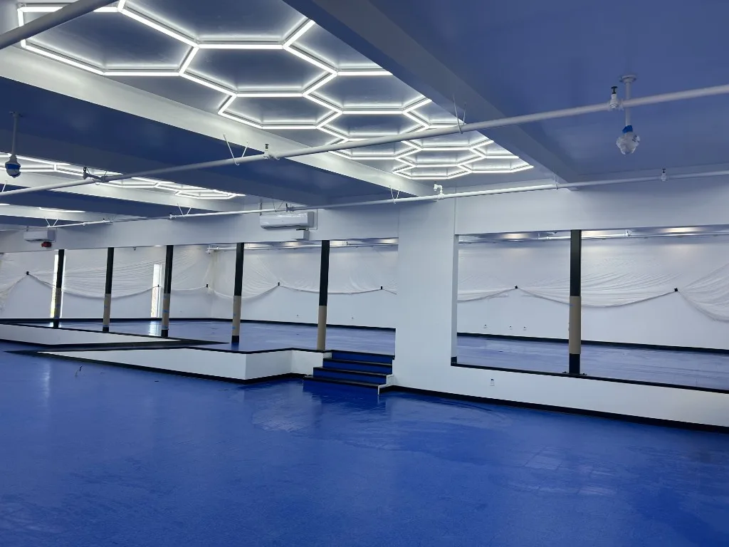 Commercial vinyl tile flooring in a showroom with hexagonal lighting